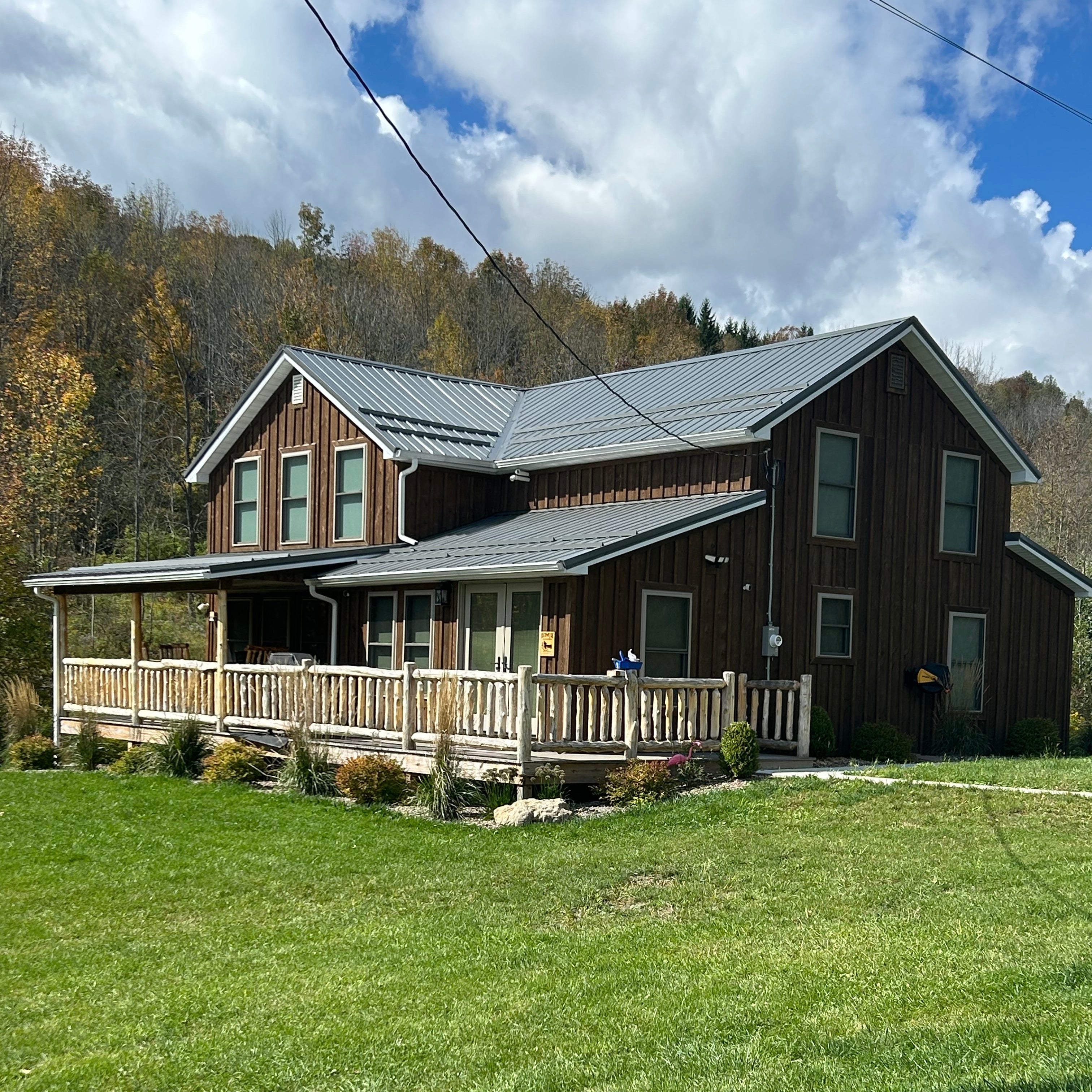 Wooden cabin with a grassy lawn and blue sky